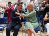 Andy Burnham embraces his wife Marie-France van Heel