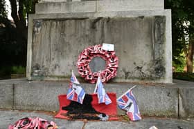 Darlaston War Memorial where a big metal plaque on the bottom of it has been stolen. The Memorial is looking very unloved and forgotten with old faded plastic poppy wreaths all around it.