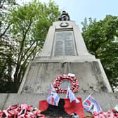 Darlaston Wat Memorial where a big metal plaque on the bottom of it has been stolen. The Memorial is looking very unloved and forgotten with old faded plastic poppy wreaths all around it.