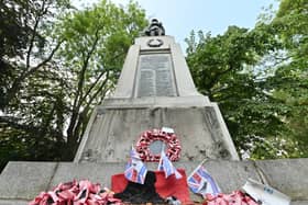 Darlaston Wat Memorial where a big metal plaque on the bottom of it has been stolen. The Memorial is looking very unloved and forgotten with old faded plastic poppy wreaths all around it.