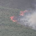 Dramatic drone footage shows the huge scale of a wildfire covering nearly 200 acres in Wales. 