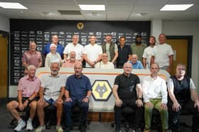 Players, staff and family line up in the Molineux media room