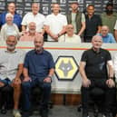 Players, staff and family line up in the Molineux media room