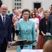 The Princess Royal stands alongside musical director Stephen Crooks as she speaks to members of the Ballyreagh Silver Band during a visit to the Castle Archdale Museum in Irvinestown
