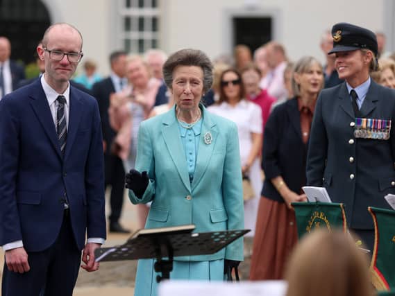 The Princess Royal stands alongside musical director Stephen Crooks as she speaks to members of the Ballyreagh Silver Band during a visit to the Castle Archdale Museum in Irvinestown