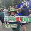 William Carroll, 11, from Aghagower, holds a 'feck the curse' sign