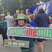 William Carroll, 11, from Aghagower, holds a 'feck the curse' sign