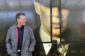 Steven Knight beside the tram which features an image of Cillian Murphy as Tommy Shelby (Matthew Cooper/PA)