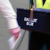 A ballot box is carried into an election count