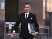 Aamer Anwar walks along the street