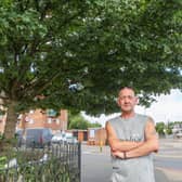 Local resident Ian Johnson standing next to the tree that has nappies on it.