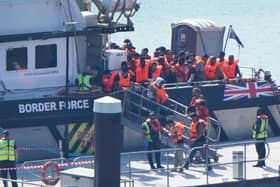 A group of people thought to be migrants are brought in to the Border Security Command compound in Dover