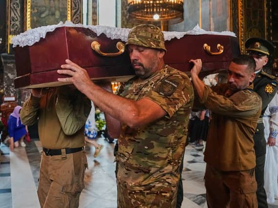 Soldiers carry a coffin