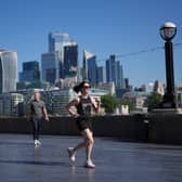 A view of the City of London, with a jogger in the foreground