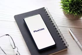 Plus500 logo on phone