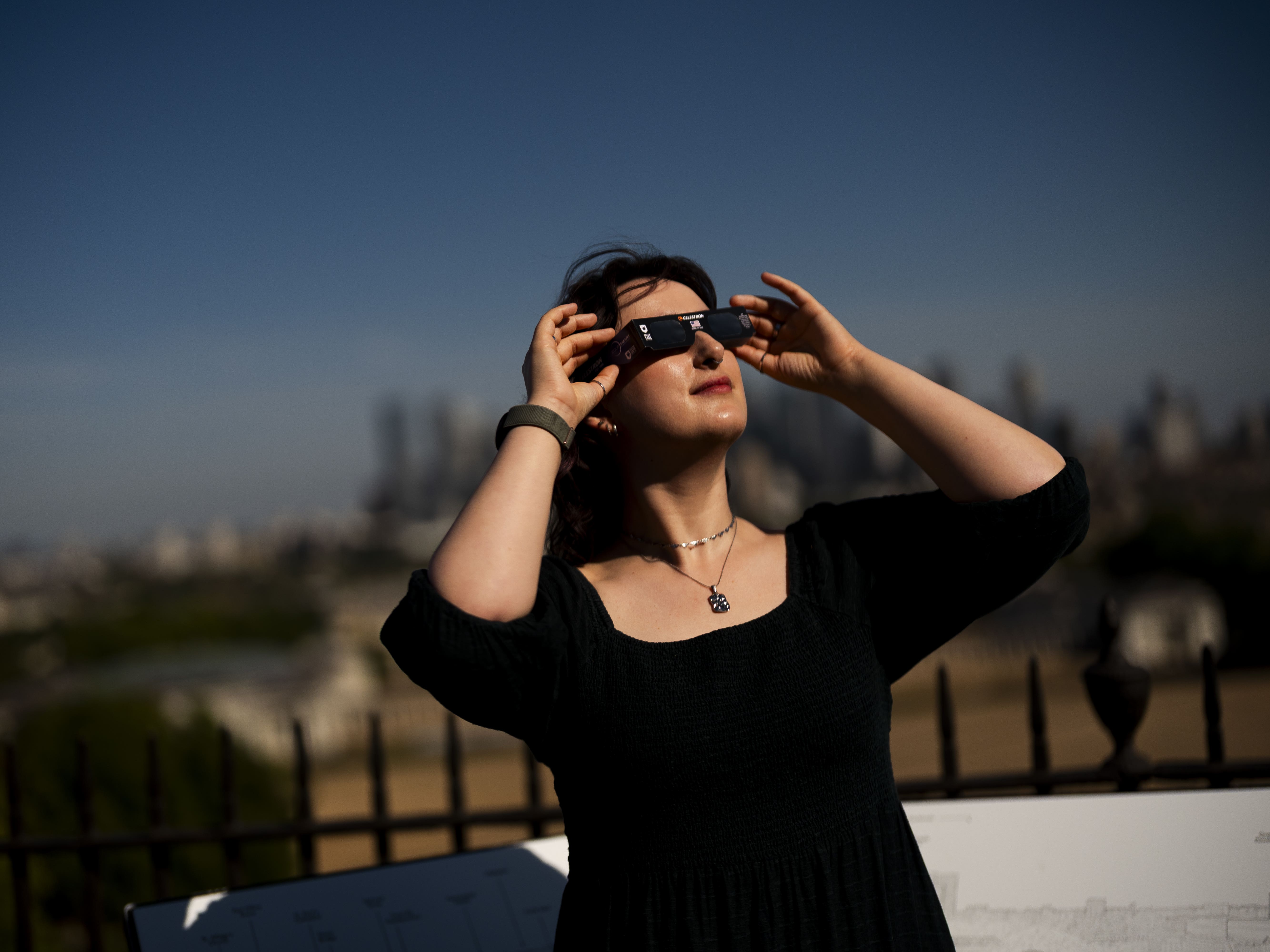 Planetarium astronomer Dr Carys Herbert demonstrates wearing Celestron solar eclipse glasses