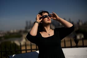Planetarium astronomer Dr Carys Herbert demonstrates wearing Celestron solar eclipse glasses