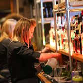 Bar staff serving customers
