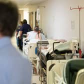 Patients on beds in corridors