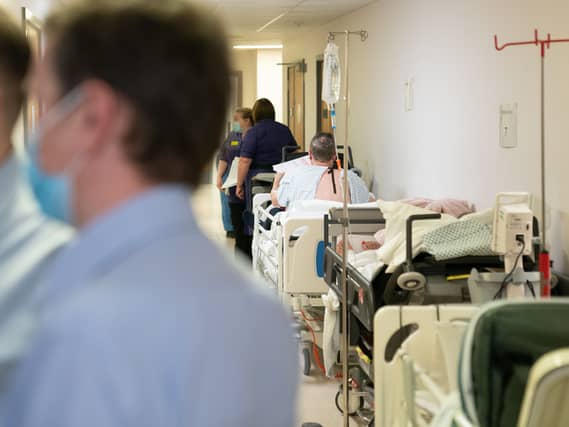 Patients on beds in corridors