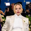Madonna wearing a white suit and bow tie