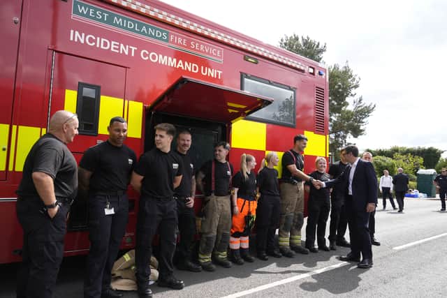 Prime Minister Andy Burnham (right) meets firefighters and staff members of the West Midlands fire service during a visit to Stourbridge to discuss the response to wildfires (Peter Byrne/PA)