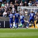 Conor Grant, third from left, scores for Notts County