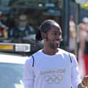 Jason Arday holding the Olympic flame