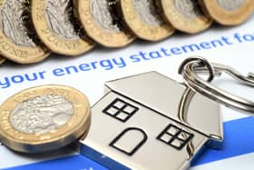 Energy statement with coins and house keyring on top
