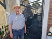 Bob Musson shows the damage caused to his house from the fire