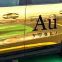 Au Vodka branding on a gold-coloured car
