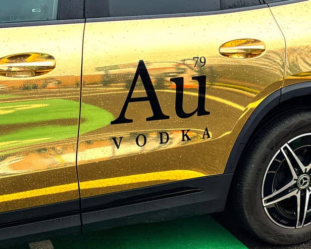 Au Vodka branding on a gold-coloured car