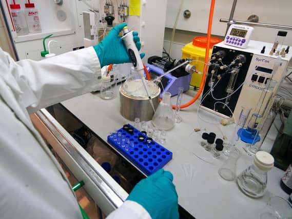 Staff work inside the AstraZeneca Laboratory in Macclesfield, England.