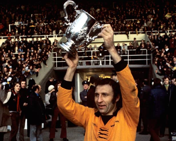 Victorious Wolverhampton Wanderers captain Mike Bailey holds the League Cup aloft in 1974