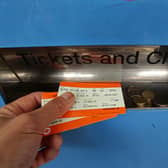 A man collecting train tickets from a machine at Finsbury Park station in north London