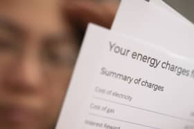 A person holding an energy bill.