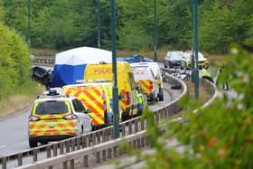 Police officers at the scene of a fatal crash involving a police car and a Volkswagen Passat on the A66 in South Bank, near Middlesbrough