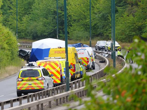Police officers at the scene of a fatal crash involving a police car and a Volkswagen Passat on the A66 in South Bank, near Middlesbrough