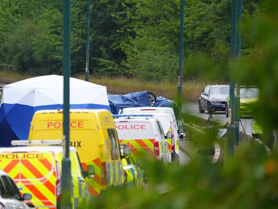 Police officers at the scene of a fatal crash involving a police car and a Volkswagen Passat on the A66 in South Bank, near Middlesbrough