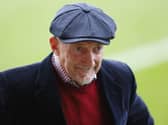 Swindon manager Ian Holloway wearing a flat cap on the touchline