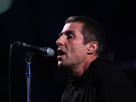 Liam Gallagher singing into a microphone