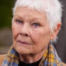 Dame Judi Dench in a brown coat and printed scarf at the Chelsea Flower Show 2026