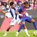 Lamine Yamal of FC Barcelona (right) is challenged by Kareem Tunde of Levante UD (Photo by Pedro Salado/Getty Images)