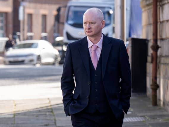 Graeme Dott walking outside, wearing a suit and tie