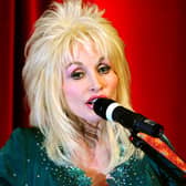 Dolly Parton speaking into a microphone