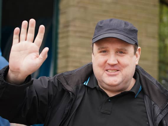 Peter Kay smiling and waving