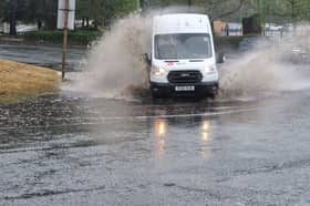 DPD Parcel delivery van wades through water on the Queslett Road roundabout
