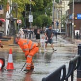 Burst water pipe in Bilston town centre, causing chaos for traders and shoppers. Lifting man hole covers for water to flow into.