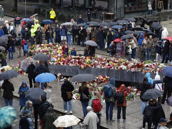 Flowers and cards are laid at the Blue Stone in Bergen