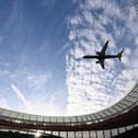 A jet flies over a stadium